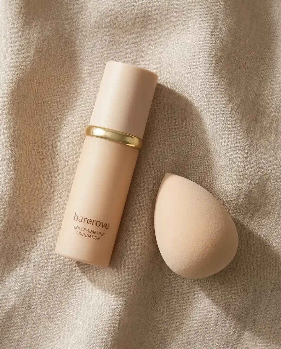 The foundation bottle and free brush laid out flat