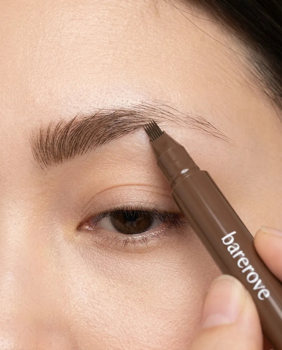The fine-forked tip building a sparse brow back to full, stroke by stroke