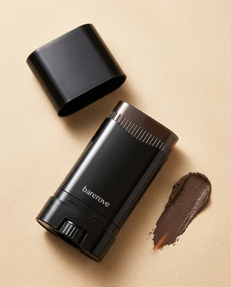 The stick beside a dark brown pigment swatch